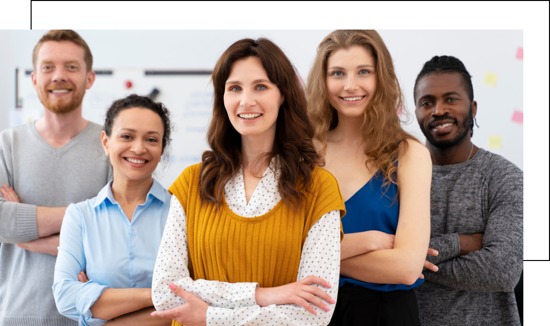 Group of five people smiling in office setting.