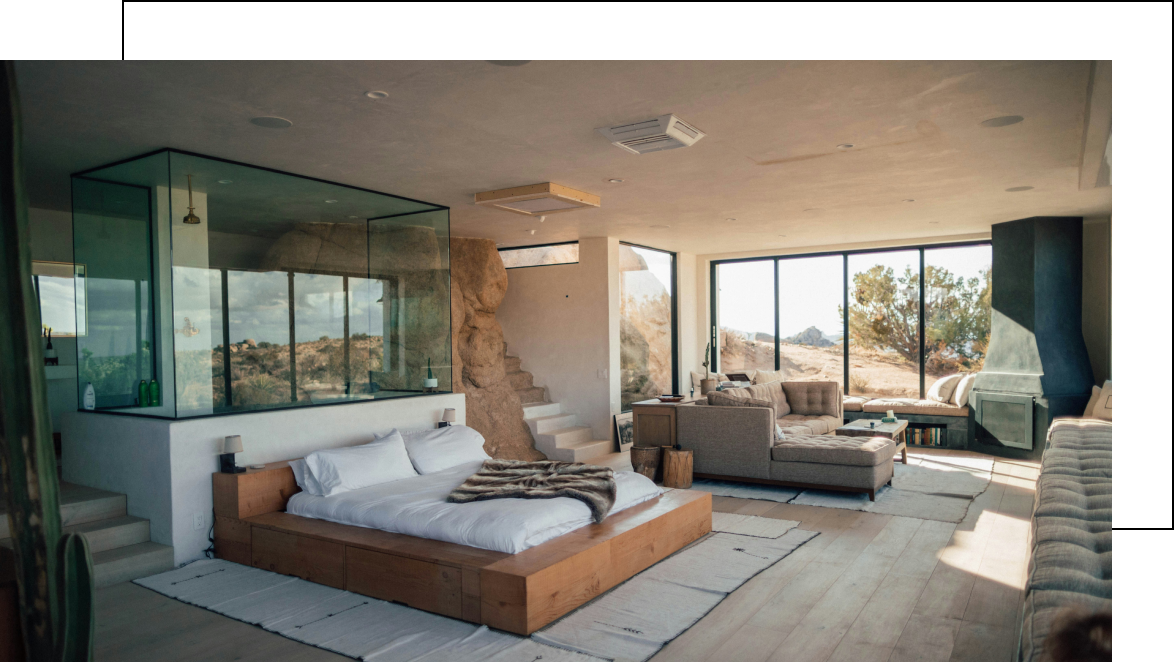 Bedroom with large windows and desert view.